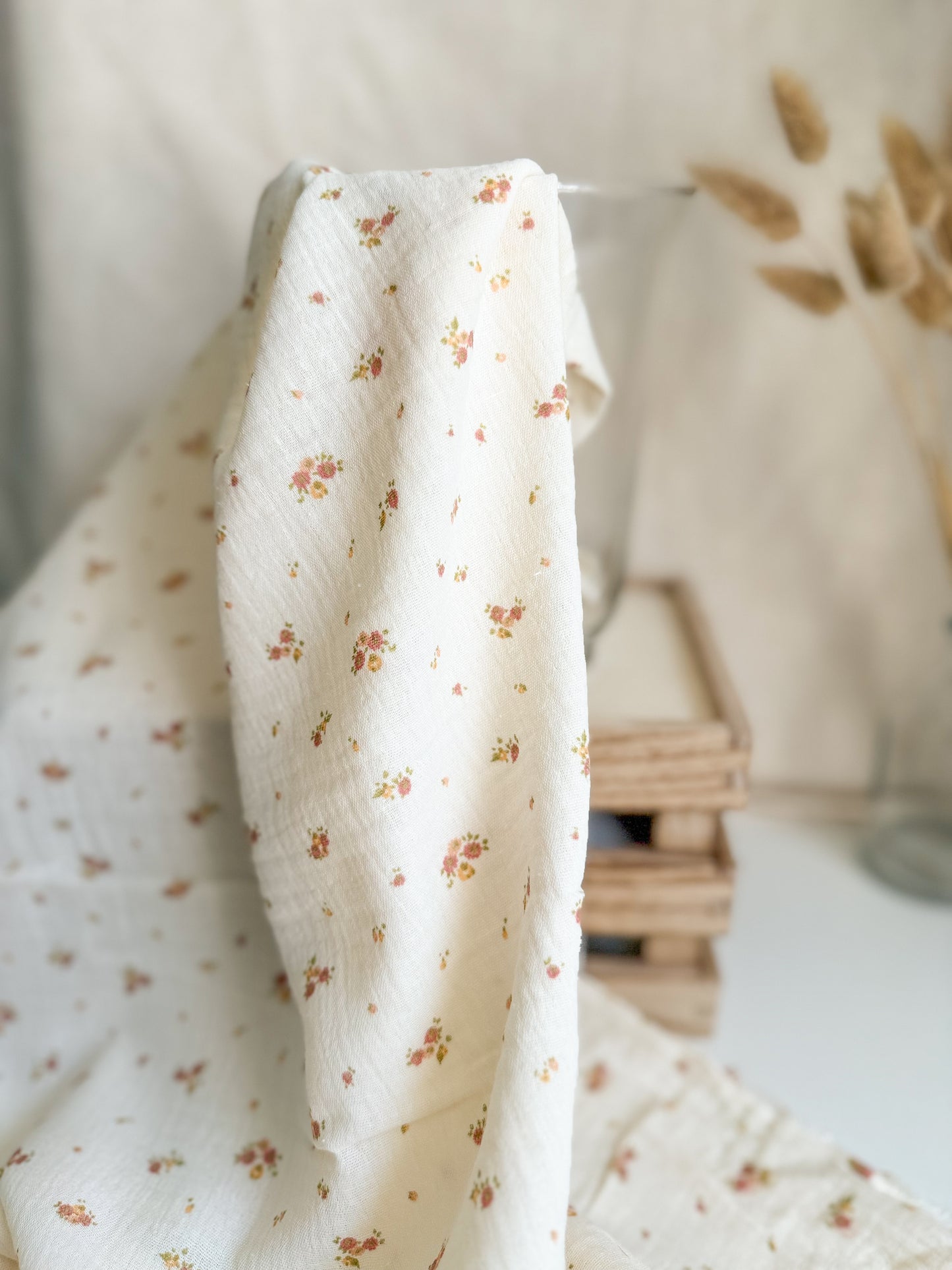 Delicate double gauze muslin fabric in with a ditsy yellow and pink floral print with an ecru background. 100% organic cotton.