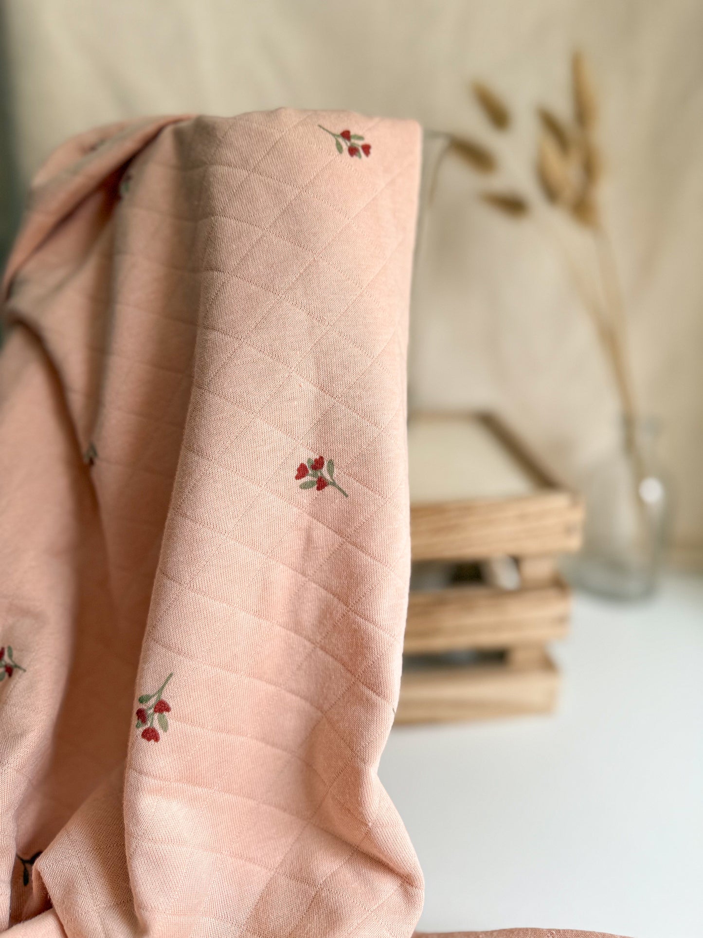 Blush coloured quilted jersey fabric with floral print