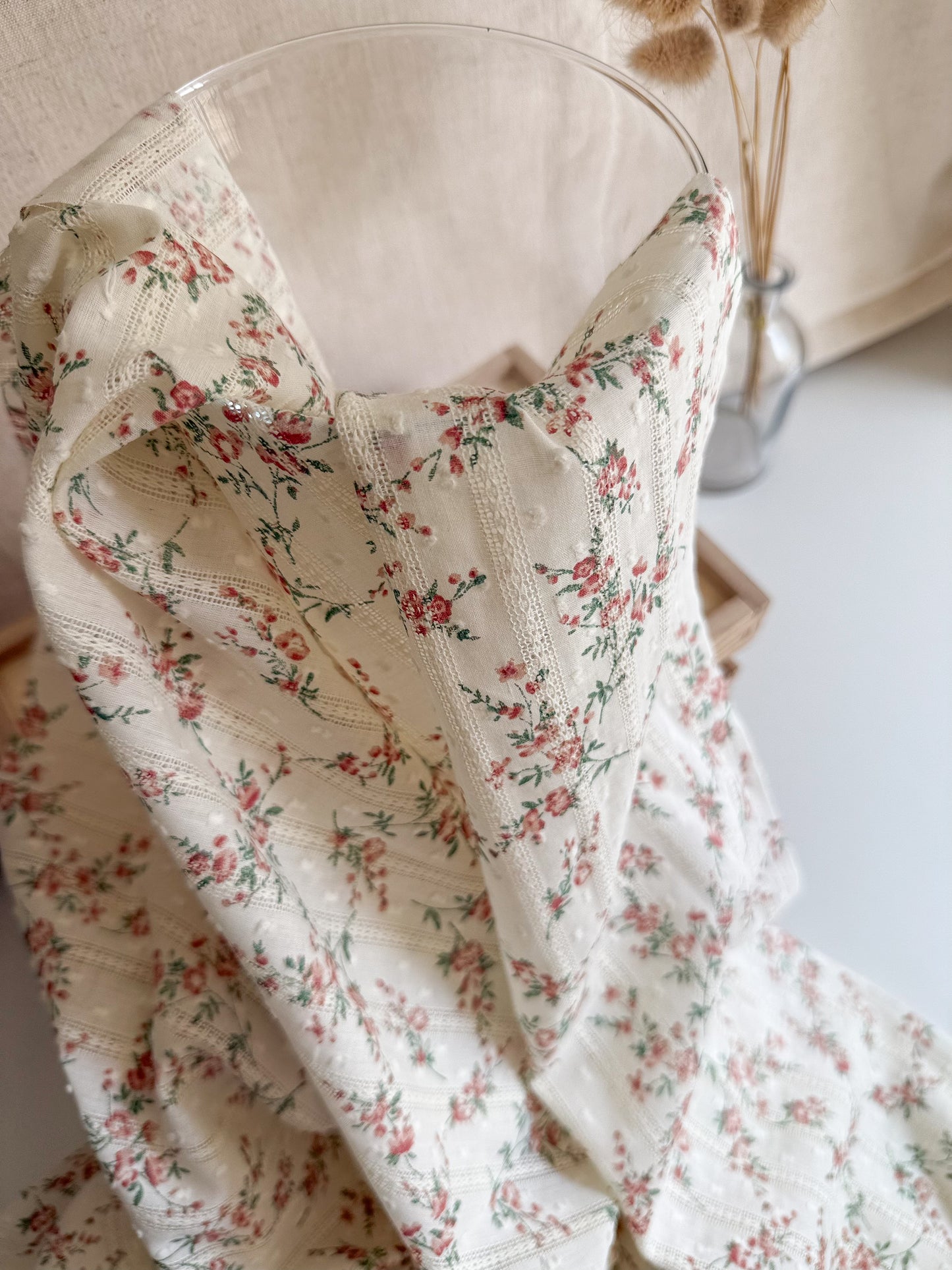 Close up of floral print swiss dot dobby cotton fabric for sewing