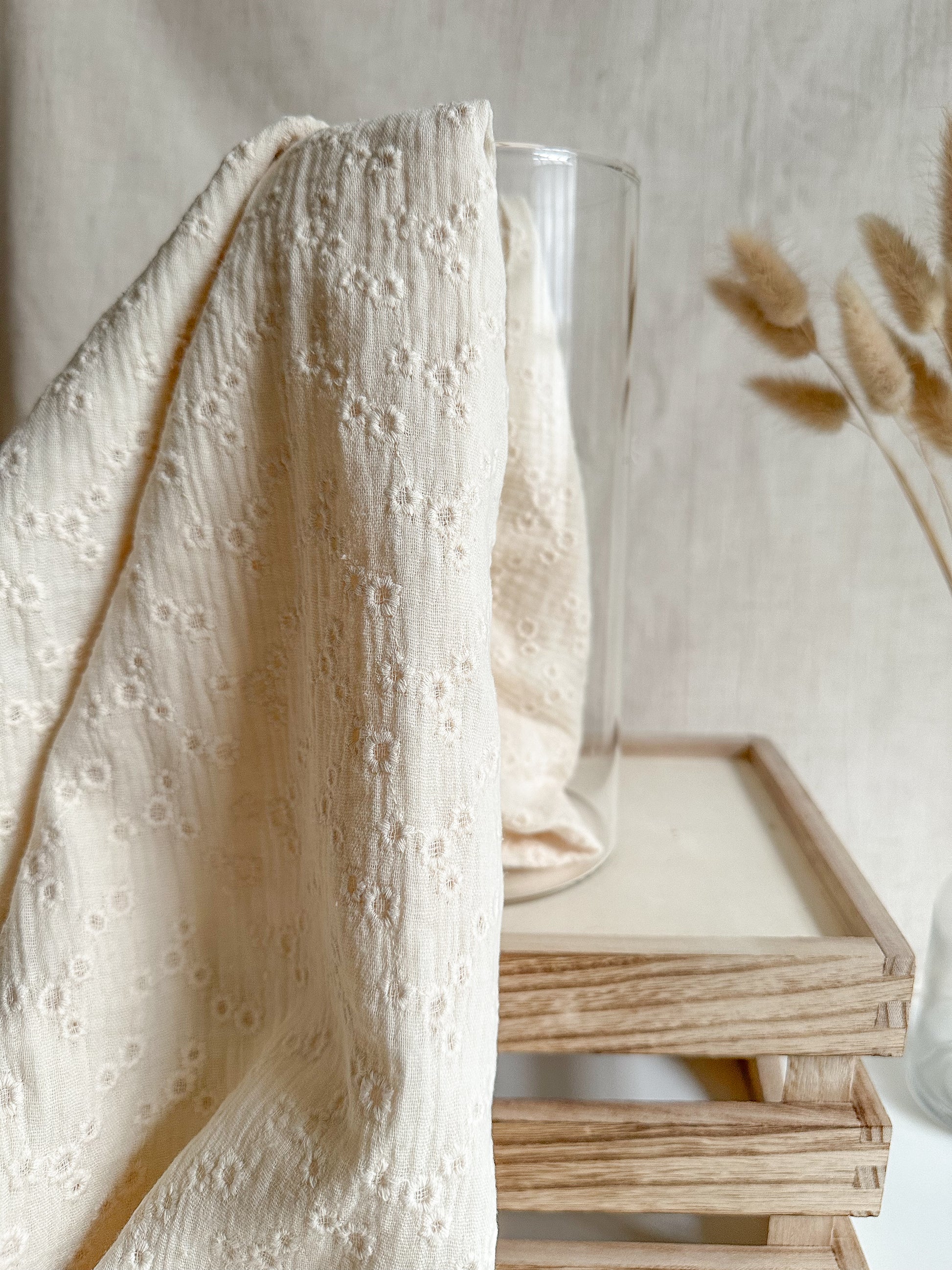 A lightweight embroidered double gauze fabric in a soft vanilla colour with floral embroidery. 