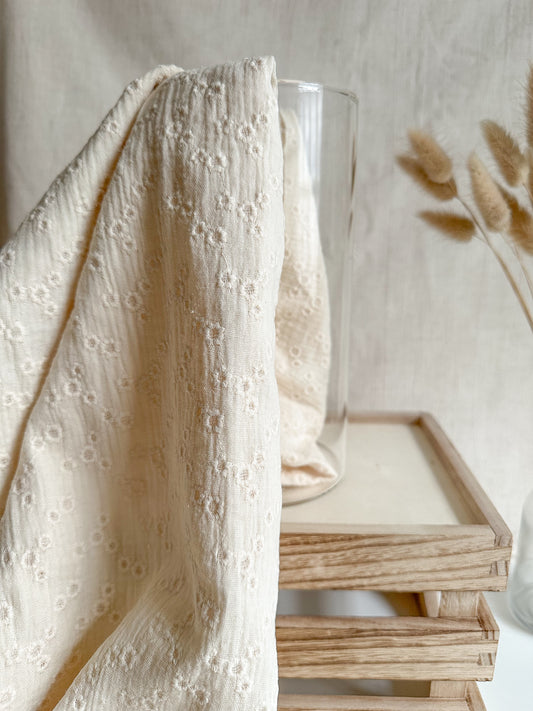 A lightweight embroidered double gauze fabric in a soft vanilla colour with floral embroidery. 