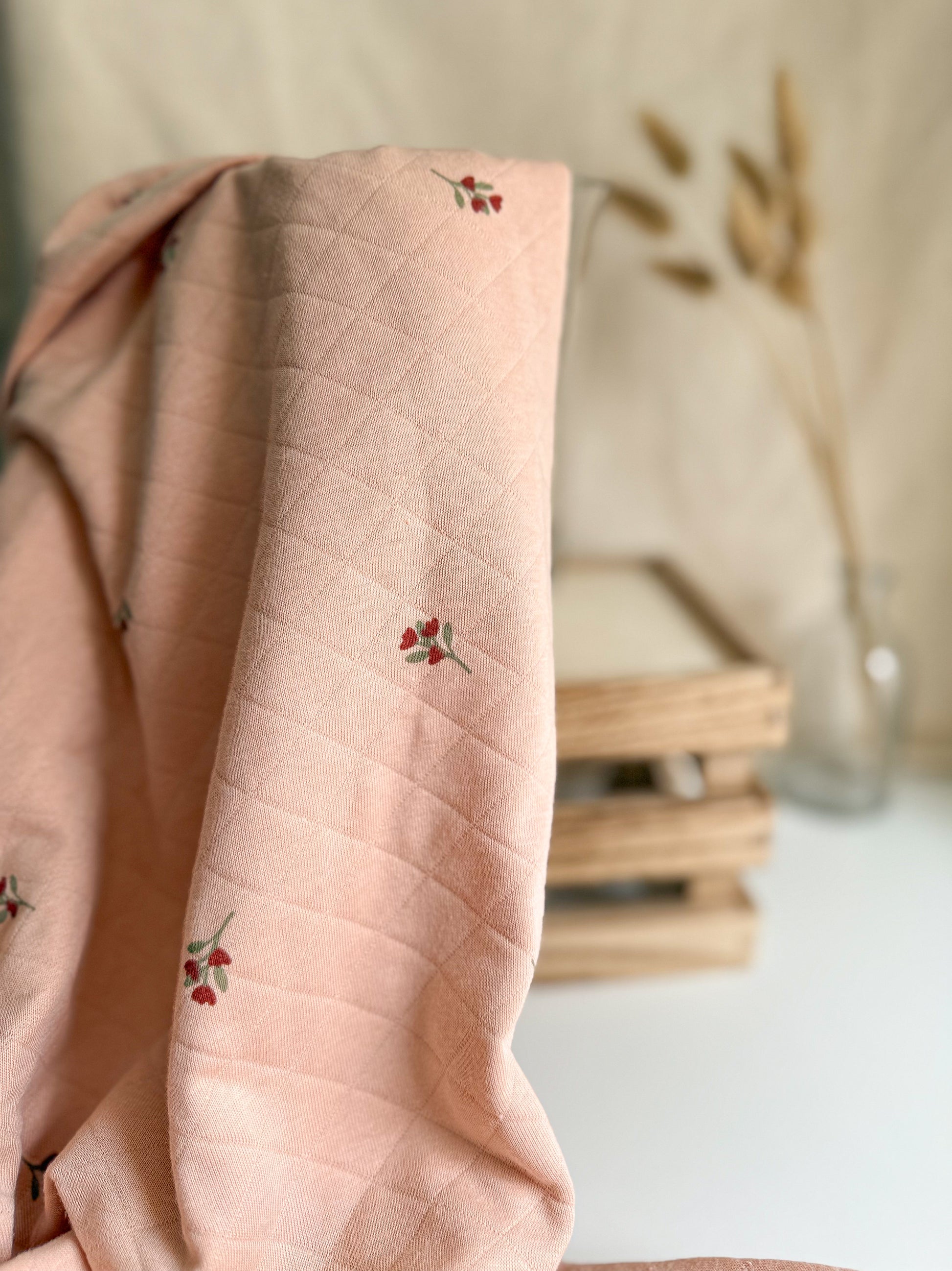 Blush coloured quilted jersey fabric with floral print 