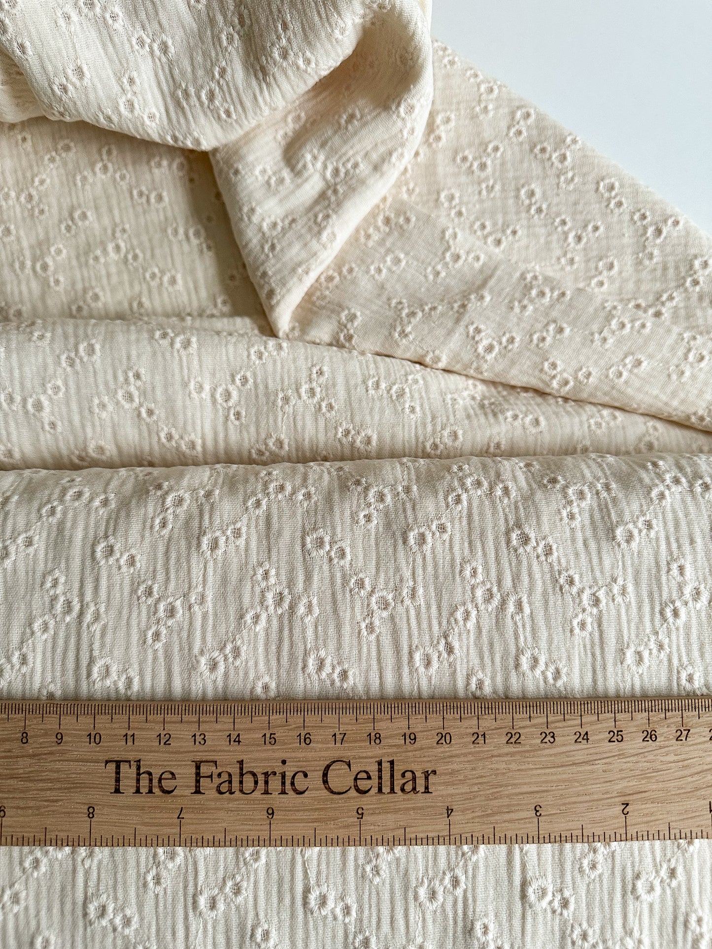 A lightweight embroidered double gauze fabric in a soft vanilla colour with small floral embroidery