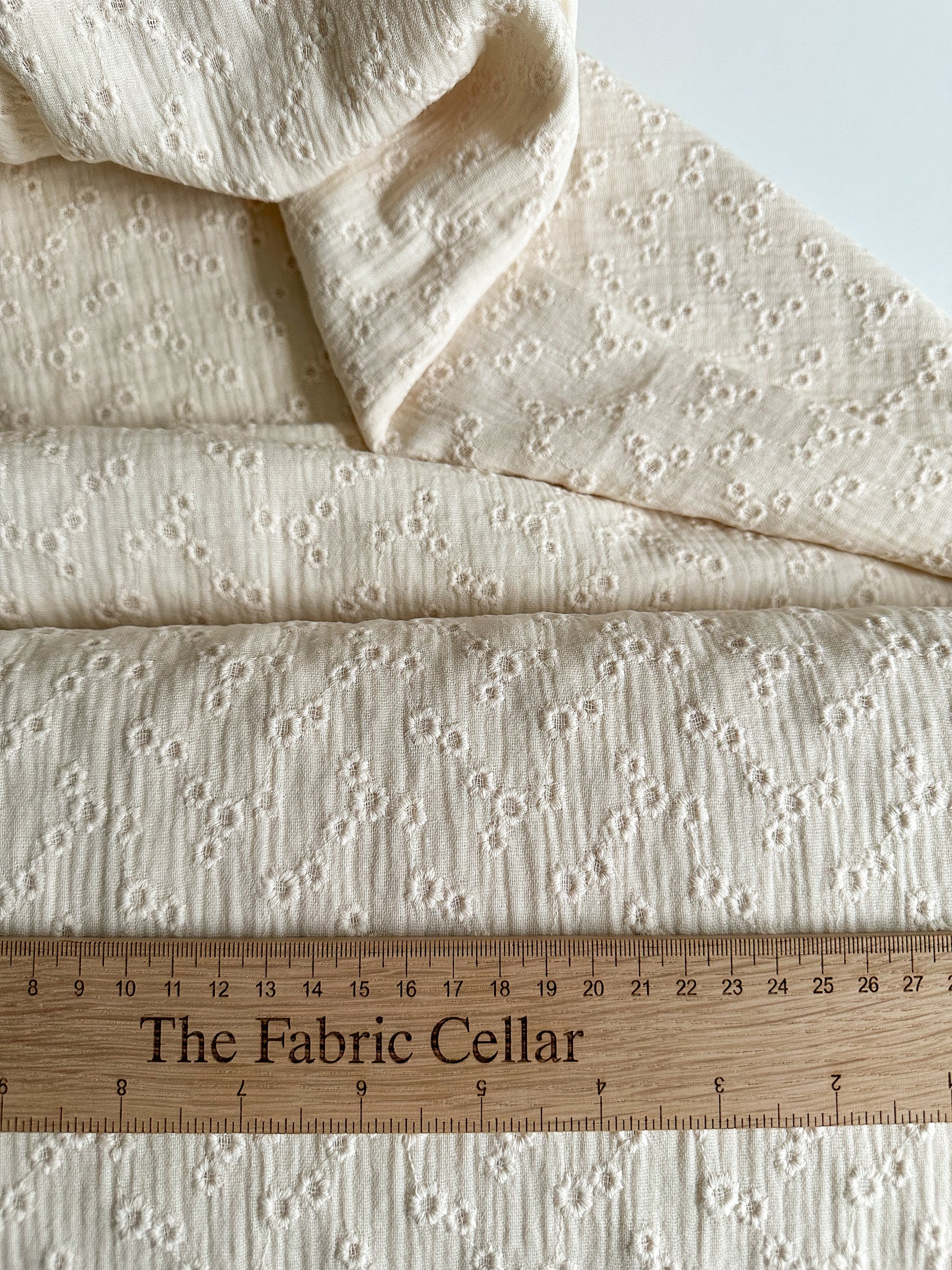 A lightweight embroidered double gauze fabric in a soft vanilla colour with small floral embroidery